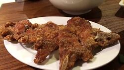 Tilt shot of people eating foods on table inside Chinese restaurant Stock Footage