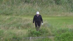 Donald Trump waves at cameras while golfing on private visit to Scotland - HD version News Clip