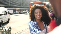 Young playful hipster couple holding hands at city sunset Stock Footage