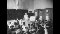 United States, 1950s: Teacher and students in classroom, students raise hands Stock Footage