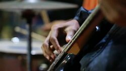 Music playing guitar concept : Young man people that guitarist plays on stage for show live in concert with light blur background Stock Footage