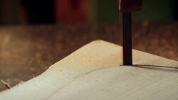 A band saw is used to shape a piece of wood which will form the seat of a chair. Stock Footage