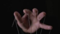 You are being manipulated concept with puppeteer hand and string Stock Footage