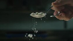 in an Italian professional kitchen a chef pours salt on a dish or in the water to boil the Italian pasta concept of healthy and light food. Stock Footage