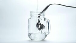 Boiling water with immersion heater Stock Footage