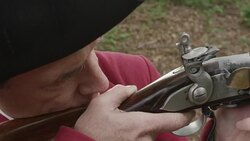 Revolutionary War soldier aiming musket with finger on the trigger Stock Footage