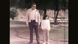 Man Talks to Girl in Park, 1970s. Stock Footage