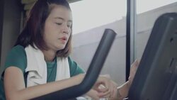 Beautiful woman cycling on the exercise bike in the gym Stock Footage