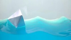 Paper boat on stormy water, dreams of traveling around world, obstacles, macro Stock Footage