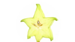 One star shaped slice of ripe carambola fruit with water drops. Slowly rotating on the turntable isolated on the white background. Close up. Macro. Stock Footage