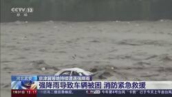 Crews rescue man clinging to car in China flood News Clip