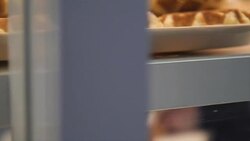 Showcase of cakes, breads,waffle, pastry in window display canteen for tasty desert food Stock Footage