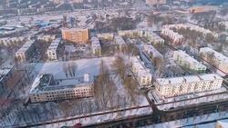 The aerial panoramic view on the winter city covered by the snow in the bright cold sunny day Stock Footage