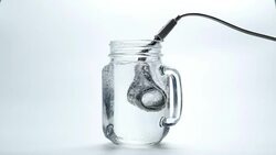 Boiling water with immersion heater Stock Footage