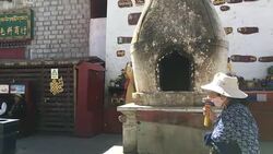Pilgrims holding prayer wheel walking on Barkhor Street. Stock Footage