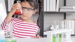 Education Topics:Funny little girl doing experiments in the laboratory.Science and education. Stock Footage
