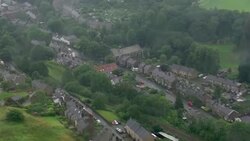 Aerial shots Whaley Bridge and damage to Toddbrook Reservoir after wall damaged by rain News Clip