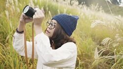 Asian tourist woman taking pictures of the mountainside with her camera at Stock Footage