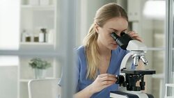 Woman Examining Samples with Microscope Stock Footage