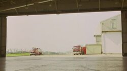 WIDE ANGLE OF PRIVATE JET, AIRPLANE PULLING IN TO HANGAR. PLANE IS HAWKER SIDDELEY HS 125-700B. 21 FPS. Stock Footage