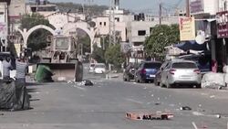 CLEAN : Palestinians throw stones at Israeli bulldozer during raid in WB city News Clip