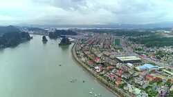 4k Aerial view over city and park with Bai Tho karst mountain Ha long bay. Halong City. Stock Footage