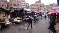 People shopping in a crowded Sana'a market during rainy season News Clip