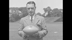 Fordham University football coach Jim Crowley demonstrates new football to be used in college games News Clip