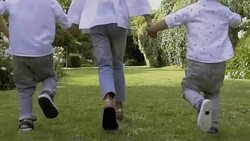 Three kids running to mother together Stock Footage