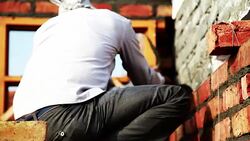 Bricklayer installing bricks on construction site Stock Footage