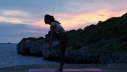Silhouette Young woman is practicing yoga at mountain sea. Stock Footage