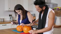 4K: Couple carving pumpkins for Halloween Stock Footage