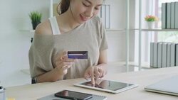 Attractive asian woman using credit card paying with digital tablet gadget. Stock Footage