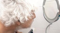 Senior man shaves off his beard Stock Footage