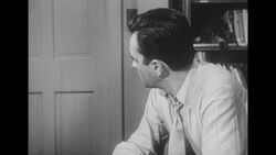 1950s: Wife looks in the mirror at vanity table Stock Footage