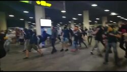 CLEAN : Police charge separatist protesters at Barcelona airport News Clip