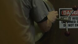 Industrial worker opening vat of cereal grist Stock Footage