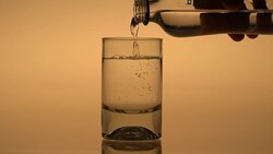 Pouring water from bottle into glass Stock Footage