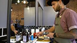 Barber cleaning and lubricating electric razor Stock Footage