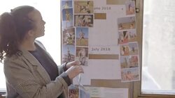 Creative designers discussing photographs in office meeting Stock Footage