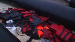 Migrant boats and life vests on beach News Clip