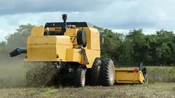 Agricultural tractor harvesting field in 4K 60fps Stock Footage