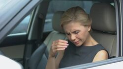 Beautiful female in automobile taking glasses off, feeling eye pain, exhaustion Stock Footage