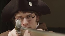 Revolutionary war soldier in tricorn hat aiming musket Stock Footage