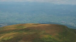 Carpathians mountains at summer. Extreme long shot. Herd of sheep are grazing on pasture. Tops of mountains covered with white clouds. Ukrainian nature landscape. Blurred background Stock Footage