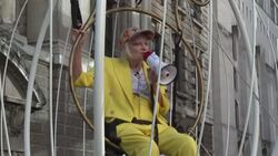 CLEAN : Vivienne Westwood suspends herself in a cage in London to protest Assange extradition trial News Clip