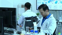 Scientists woman holding smartphone and working in modern laboratory or medical center. Concept of science, testing development and lab industry. Stock Footage