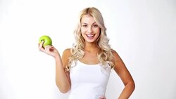 happy beautiful young woman with green apple Stock Footage