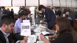 Dealers crowd trading hall for International Diamond Week Instructional Video