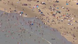 People on beach at Camber Sands on the hottest day in 17 years News Clip